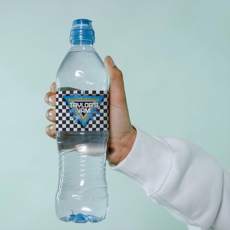May include: A clear plastic water bottle with a blue cap and a label that says "Taylor's Jam" in a blue and yellow triangle with a checkered pattern.