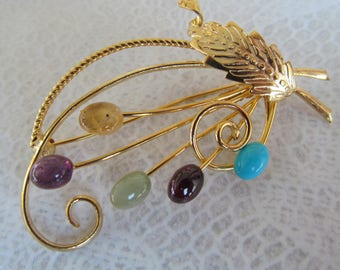 Signed Swoboda floral spray with genuine multi gemstones w gold colored metal