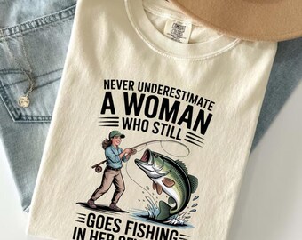 Never Underestimate A Woman Who Still Goes Fishing In Her Seventies T-Shirt, Funny Fishing Grandma Gift, Angler Graphic Tee