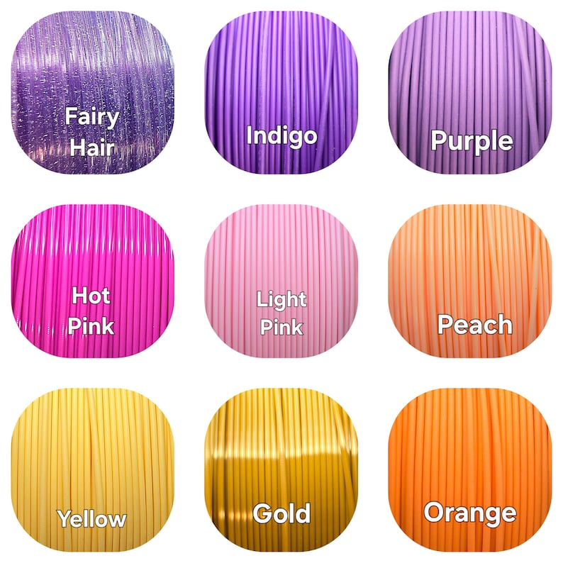 May include: Nine spools of 3D printing filament in various colors, including Fairy Hair, Indigo, Purple, Hot Pink, Light Pink, Peach, Yellow, Gold, and Orange. Each spool is labeled with its color name.