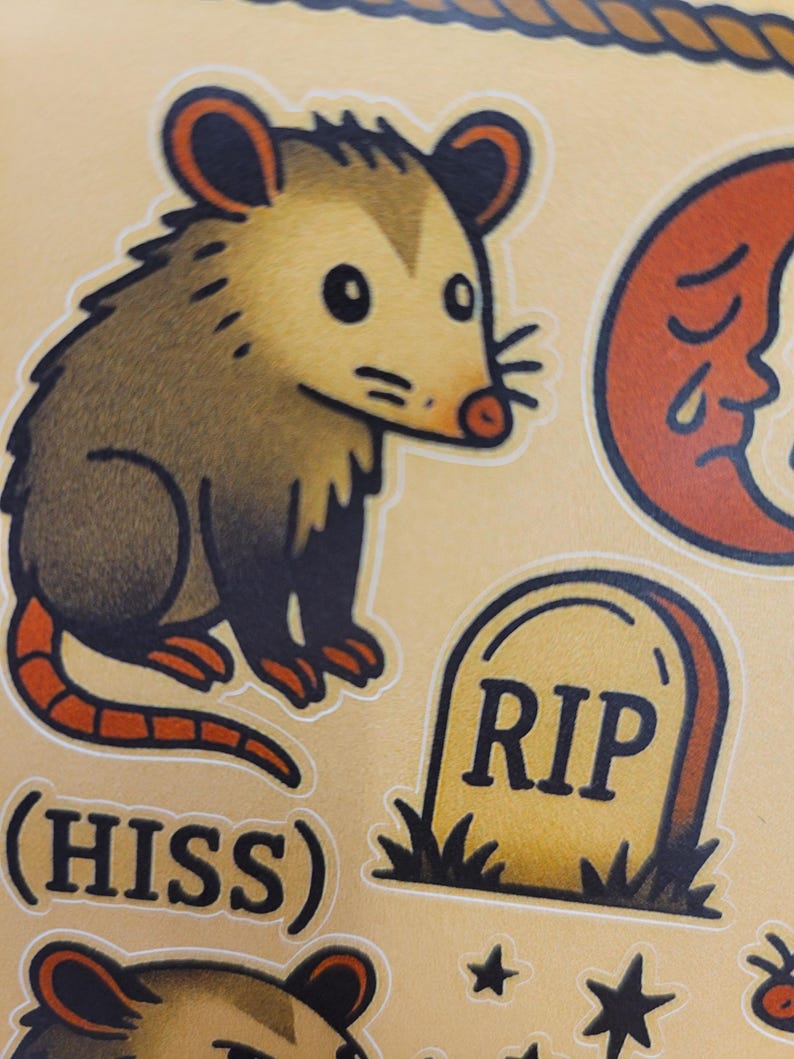 May include: A sheet of stickers featuring a cartoon opossum, a crescent moon with a face, a tombstone with "RIP" on it, and the word "(HISS)". The opossum is brown and tan with a red tail.