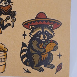 May include: A raccoon wearing a red and brown sombrero, holding a taco. The raccoon is brown and black with a striped tail. The image has a vintage tattoo style with star and leaf accents.