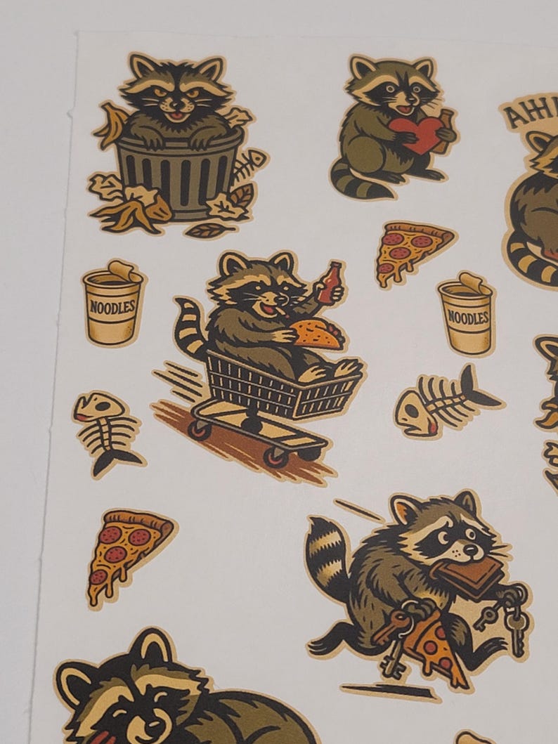 May include: A sheet of stickers featuring cartoon raccoons in various poses. One raccoon is in a trash can, another holds a heart, and others are eating pizza and noodles. The stickers have a vintage, hand-drawn style with brown, tan, and olive green colors.