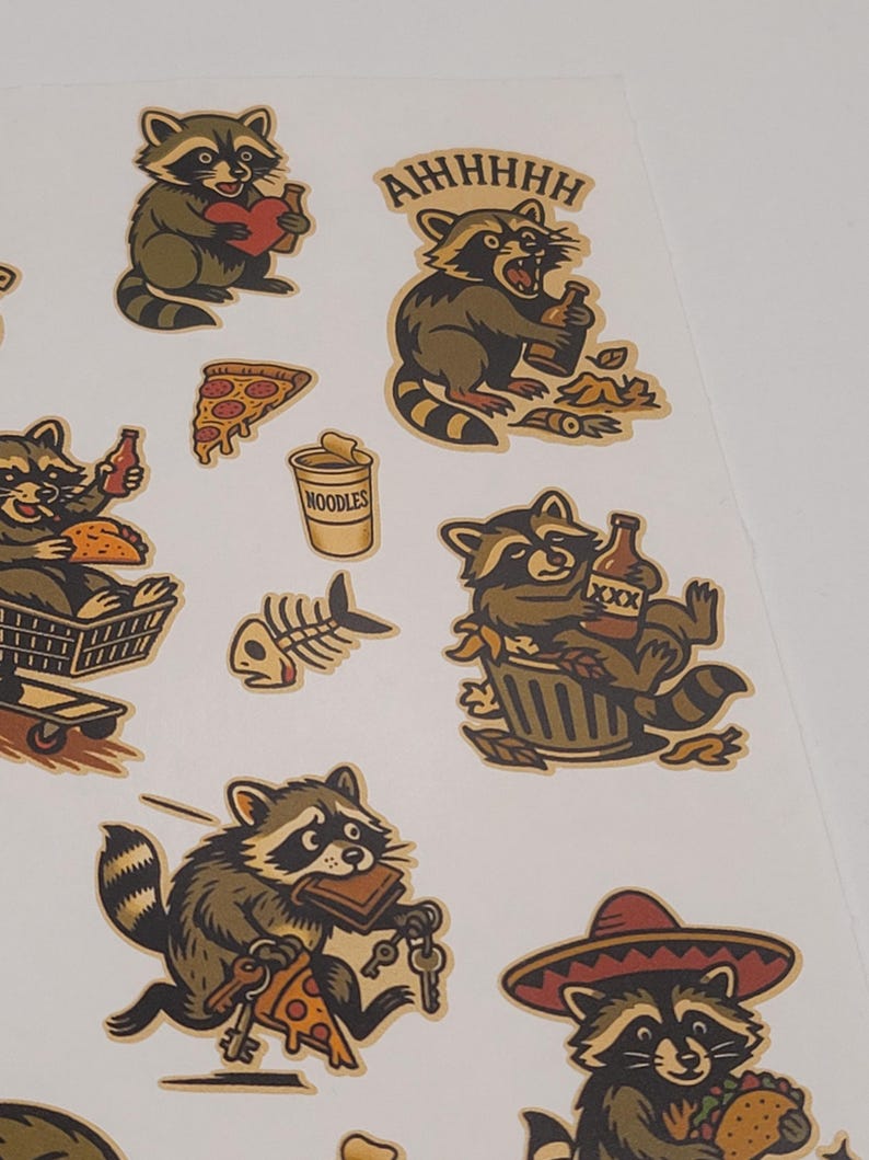 May include: Sheet of raccoon stickers in various poses, holding a heart, a bottle, pizza, and keys. One sticker has the text "AHHHHH". The stickers are in shades of brown, tan, and black, with a white background.