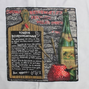 May include: A vintage-style illustration of a fondue recipe with a red apple, a bottle of wine, and a wooden cutting board with a chalkboard. The chalkboard has the text "Fondue Bourguignonne" and instructions for preparing the dish. The text reads "6.75 8.40 15.15".