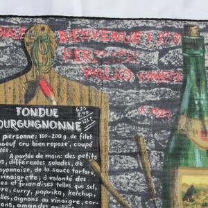 May include: A black and white illustration of a wooden cutting board with a chalkboard sign that reads "Fondue Bourguignonne". The sign lists ingredients and instructions for preparing the dish. A bottle of wine is pictured in the background.