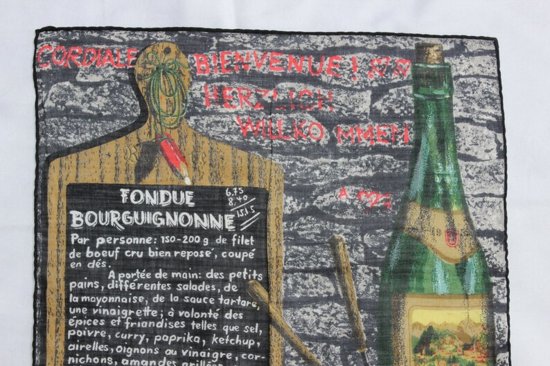 May include: A black and white illustration of a wooden cutting board with a chalkboard sign that reads "Fondue Bourguignonne". The sign lists ingredients and instructions for preparing the dish. A bottle of wine is pictured in the background.