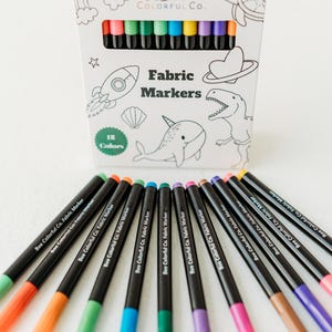 Bee Colorful Co. fabric marker set: 12 rainbow colors. Non-toxic, permanent pens for kids' coloring pajamas, t-shirts, canvas & fabric crafts. Fine tips for detailed designs. Perfect for DIY projects, personalized gifts, and fabric art. ASTM D-4236 certified, ensuring safety for children. Use on clothes, textiles, and apparel for lasting color and creative play. Enhance any project with these easy-to-use, vibrant markers.