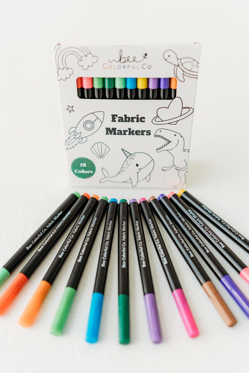 Bee Colorful Co. fabric marker set: 12 rainbow colors. Non-toxic, permanent pens for kids' coloring pajamas, t-shirts, canvas & fabric crafts. Fine tips for detailed designs. Perfect for DIY projects, personalized gifts, and fabric art. ASTM D-4236 certified, ensuring safety for children. Use on clothes, textiles, and apparel for lasting color and creative play. Enhance any project with these easy-to-use, vibrant markers.