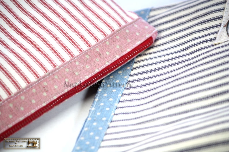 May include: Two fabric zipper pouches with different patterns. One pouch is red and white striped with a pink polka dot trim. The other pouch is blue and white striped with a blue polka dot trim.
