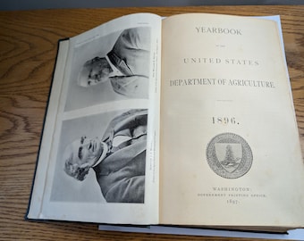 May include: An open antique book titled "Yearbook" from the United States Department of Agriculture, dated 1896. The book features black and white portraits and a seal. Published by the Government Printing Office in 1897.