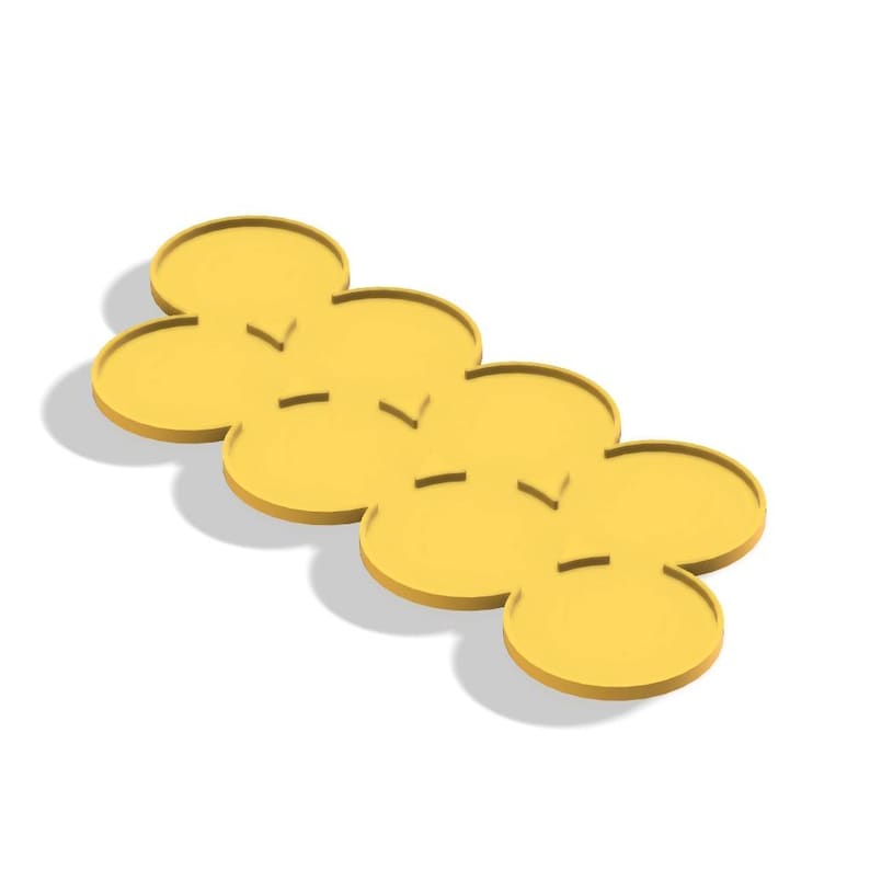 May include: A set of four daisy-shaped yellow silicone coasters. Each coaster has a series of small, horizontal indentations. The coasters are arranged in a row, casting a shadow on a white surface.