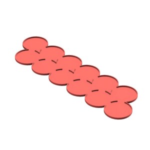 May include: A red, flower-shaped coaster set. The set is made of a solid material and features a series of connected, overlapping flower shapes. Each flower has a small, horizontal cut. The coasters are arranged in a line.