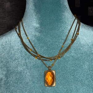 Coldwater Creek brass-toned faceted metal necklace with oval pendant