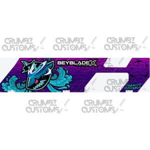 May include: A purple and blue graphic design featuring a shark with water waves and the text "BEYBLADE X". The design also includes the text "CRUMBZ CUSTOMS" in white.