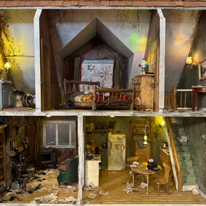 May include: A dollhouse with three rooms, a bedroom, a kitchen, and a living room. The dollhouse is made of wood and has a white paint finish. The rooms are furnished with miniature furniture, including a bed, a stove, a table, and chairs. The dollhouse is decorated with miniature accessories, such as a lamp, a rug, and a picture.