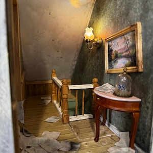 May include: A miniature dollhouse room with a wooden staircase, a small table with a glass dome, and a framed picture on the wall. The room is decorated with a vintage aesthetic, with a worn wooden floor and a dusty, textured wall.