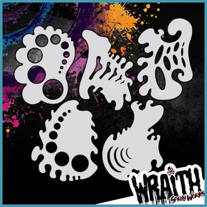 May include: Set of five white plastic stencils with abstract designs. The stencils are shaped like organic forms with circles, swirls, and dots. The stencils are arranged on a black background with colorful paint splatters.