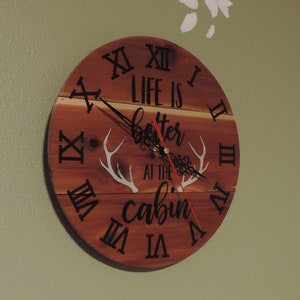 Rustic Cedar Cabin Wall Clock – 10″ Silent Wooden Timepiece with “Life Is Better at the Cabin” Design