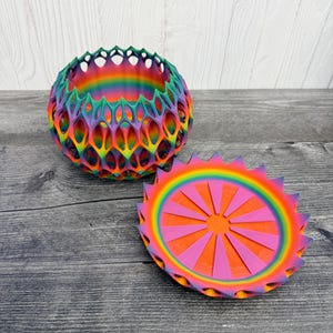 May include: A set of three ceramic mugs with a speckled, matte finish. The mugs are in shades of cream, light gray, and dark gray. Each mug has a simple, minimalist design and a rounded handle. The mugs are stacked on top of each other.