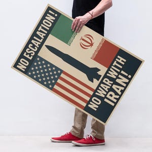 May include: A poster with the text "NO ESCALATION!" and "NO WAR WITH IRAN!" features the American and Iranian flags, along with a dark blue missile graphic. The poster is held by a person wearing red shoes.