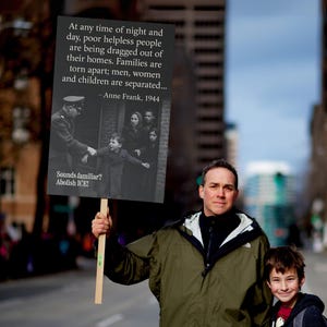 May include: A sign held by a person with the text: "At any time of night and day, poor helpless people are being dragged out of their homes. Families are torn apart; men, women and children are separated... - Anne Frank, 1944. Sounds familiar? Abolish ICE!"