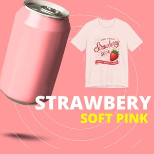 May include: A light pink aluminum soda can positioned next to a light pink t-shirt featuring a graphic of a red strawberry and the text "SWEET & BRIGHT Strawberry SODA SWEET BRIGHT BUBBLY" printed in red on the front of the garment.