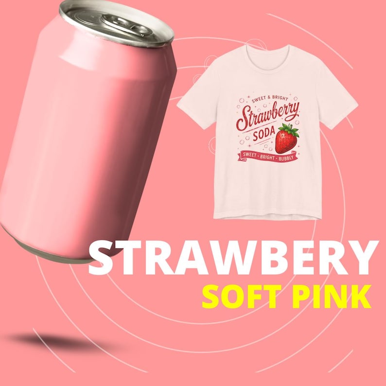 May include: A light pink aluminum soda can positioned next to a light pink t-shirt featuring a graphic of a red strawberry and the text "SWEET & BRIGHT Strawberry SODA SWEET BRIGHT BUBBLY" printed in red on the front of the garment.