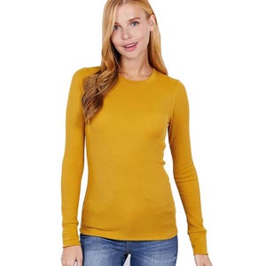 May include: A long-sleeved, mustard yellow, ribbed knit shirt.