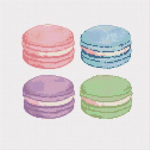 May include: Four colorful macarons, each with a white filling. The macarons are pink, blue, purple, and green.