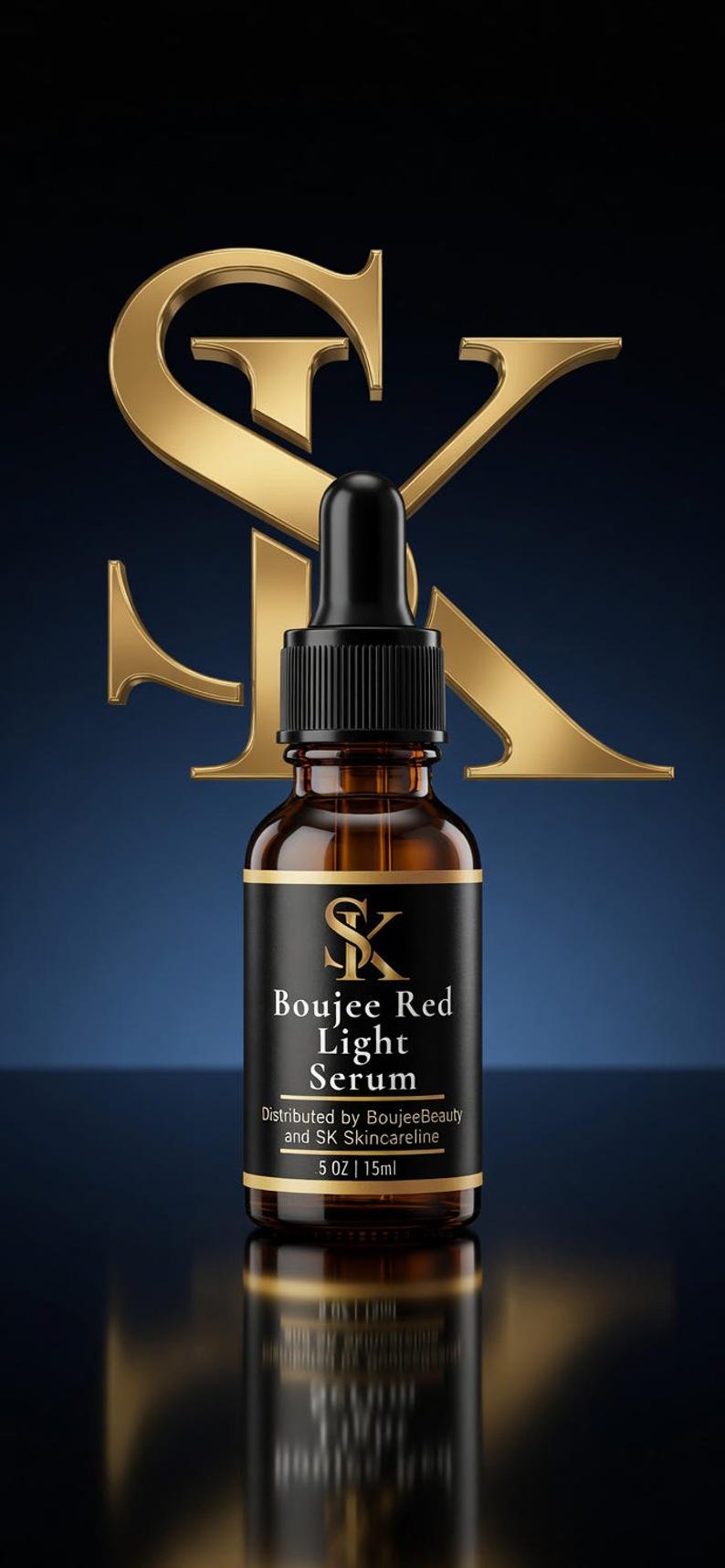 May include: A brown glass bottle with a black dropper and a black label. The label reads "Boujee Red Light Serum" with a gold logo. A large gold "SK" logo is behind the bottle. The bottle contains 0.5 oz / 15ml.