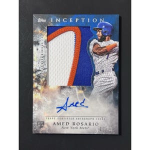 May include: A Topps Inception trading card featuring Amed Rosario of the New York Mets. The card includes a blue and white jersey patch, a blue ink autograph, and a printed image of the player in a pinstriped uniform with a blue batting helmet.