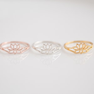May include: Three delicate rings featuring a lotus flower design. The rings are available in gold, silver, and rose gold.