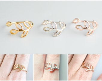 May include: Three delicate leaf-shaped rings in gold, rose gold, and silver. The rings are open and adjustable to fit most finger sizes.