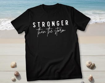 A Christian T-shirt,  stronger than the storm . Religious inspiration tee.