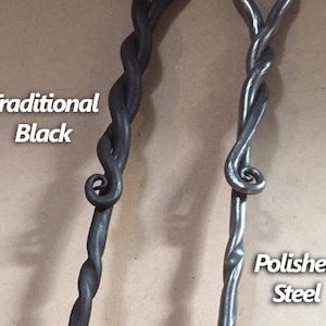 May include: Two metal fireplace tools with twisted handles. One handle is black and the other is polished steel. The text "Traditional Black" is on the left and "Polished Steel" is on the right.