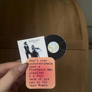 May include: A collection of stickers featuring Fleetwood Mac's "Rumours" album cover and a vinyl record. One sticker has the text: "Don't ever underestimate what a Fleetwood Mac playlist & a full tank of gas can do for that Woman."