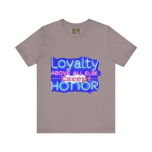 May include: A heather grey t-shirt with a neon blue and pink graphic that reads "Loyalty Above All Else Except Honor".