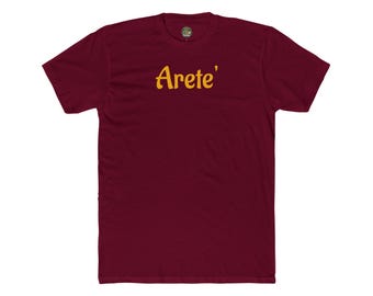May include: A maroon t-shirt with the word "Arete'" in yellow script across the chest. The shirt has short sleeves and a crew neck. The fabric appears to be a soft cotton blend.