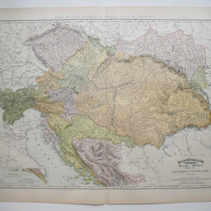 May include: A vintage map of Austria-Hungary from the Rand McNally & Company's Indexed Atlas of the World. The map features detailed geographical information with various colors, including green, yellow, and purple, and includes the Adriatic Sea.