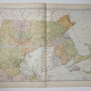 May include: A vintage map of Massachusetts, showing the state's counties and major cities. The map is divided into two sections, with the northern section showing the western part of the state and the southern section showing the eastern part of the state. The map is printed in a variety of colors, including green, yellow, and brown. The map is titled "Rand McNally & Company's Indexed Atlas of the World."