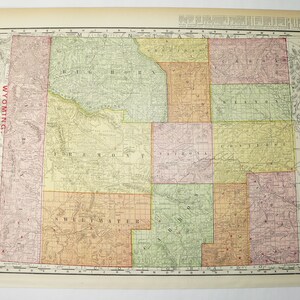 May include: A vintage map of Wyoming, showing the state's counties and their boundaries. The map is printed in black and white with colored accents, and includes a key for identifying the different counties. The map is titled "Wyoming" and is part of a larger atlas.