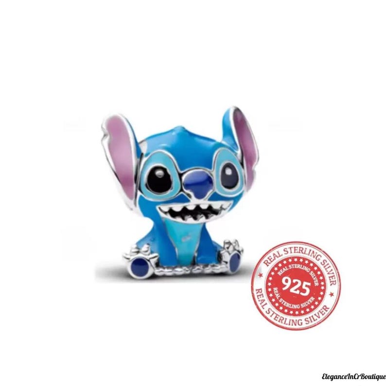 May include: A blue and silver charm featuring the character Stitch from the Disney movie Lilo & Stitch. The charm has large black eyes, a wide grin, and large ears with pink accents. The charm is marked with a "Real Sterling Silver 925" stamp.