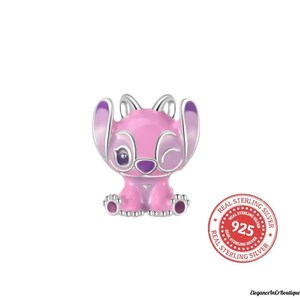 May include: A pink and silver charm featuring a cartoon character with large ears and a winking expression. The charm is made of sterling silver and has a round stamp that says "Real Sterling Silver 925".