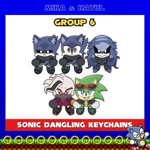May include: A set of five Sonic the Hedgehog character keychains. The keychains feature a blue hedgehog, a green hedgehog, a white wolf, a black wolf, and a purple wolf. The keychains are all in a chibi style and have a dangling design. The text "SONIC DANGLING KEYCHAINS" is at the bottom of the image. The text "GROUP 6" is at the top of the image.