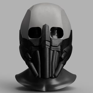 Puede incluir: Un casco futurista negro y gris con un diseño distintivo. El casco presenta una sección superior lisa de color gris claro y una sección inferior negra angular compleja con aberturas para los ojos y un protector nasal prominente. El diseño sugiere un tema de ciencia ficción o cosplay.
