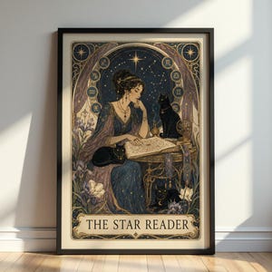 May include: A framed art print titled THE STAR READER featuring a person in a blue gown reading a book at a table with three black cats. The background displays a starry night sky, zodiac symbols, and purple iris flowers in a decorative border.