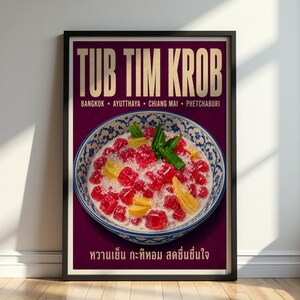 May include: A framed poster featuring a bowl of Tub Tim Krob, a Thai dessert with red water chestnut cubes, yellow jackfruit, and green pandan leaves in coconut milk. The text reads TUB TIM KROB, BANGKOK, AYUTTHAYA, CHIANG MAI, PHETCHABURI.