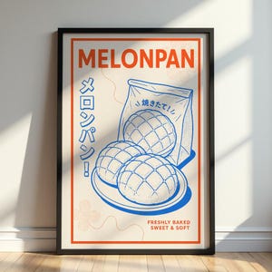 May include: A framed poster featuring a blue line art illustration of three melonpan buns on a plate and in a bag. The text reads MELONPAN, the Japanese characters メロンパン, 焼きたて, and the English text FRESHLY BAKED SWEET & SOFT.