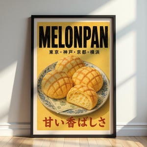 May include: Framed poster featuring the word "MELONPAN" in bold black letters. Below, Japanese text and an image of four melonpan buns on a decorative plate. One bun is cut in half, revealing the interior. The background is yellow.